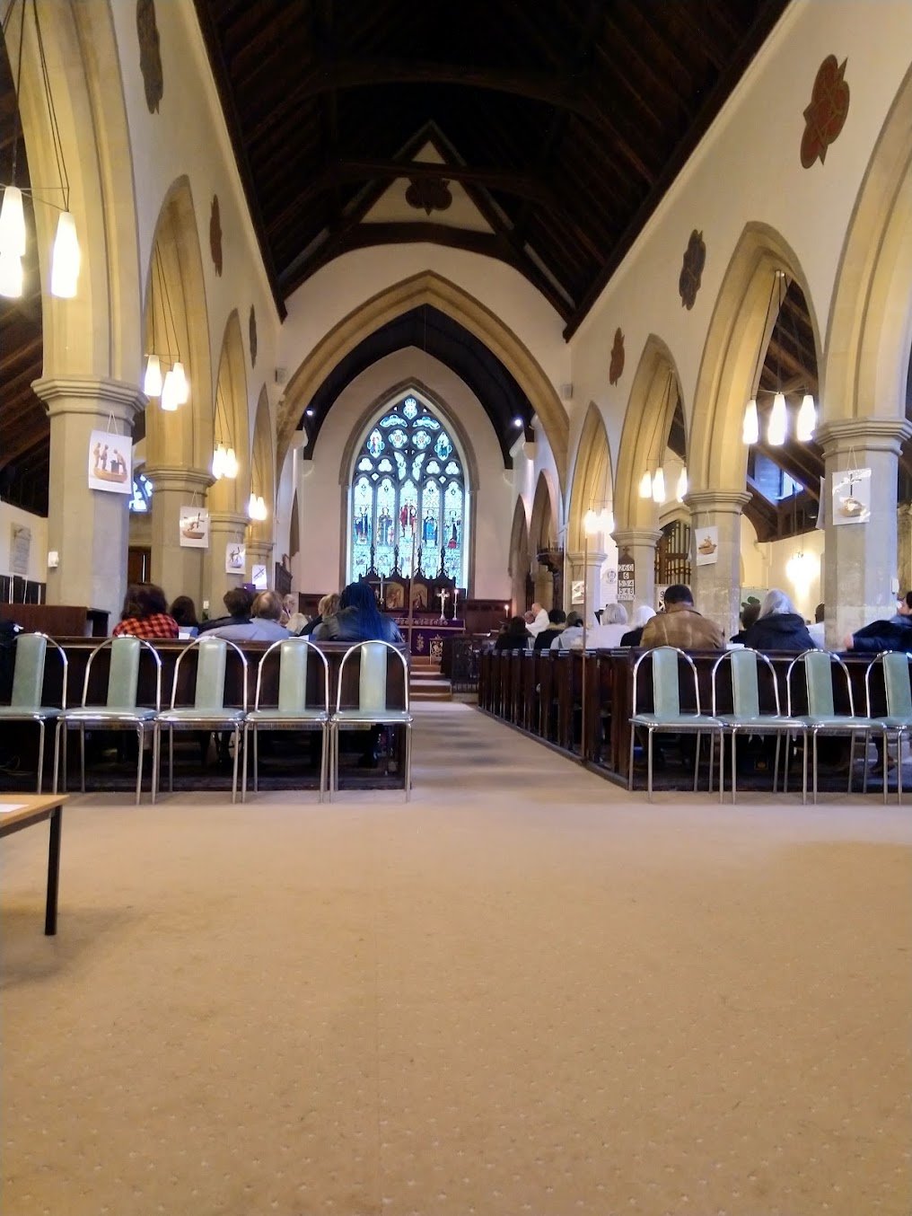 The nave of St Nicholas Church looking towards the altar and east window during a service