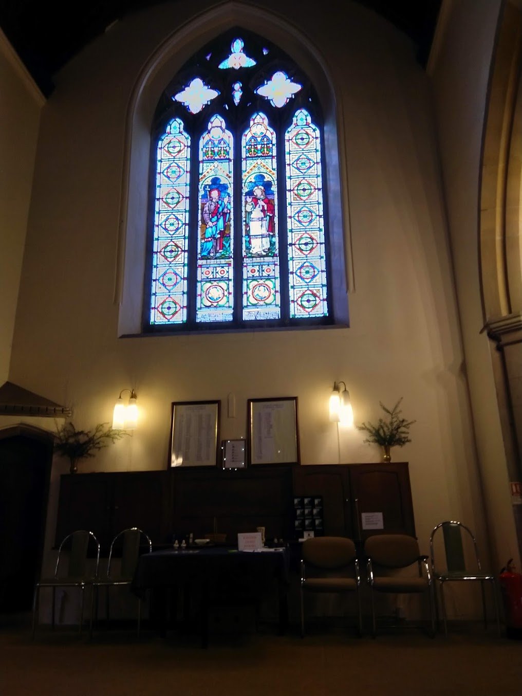 The stained-glass east window above the altar